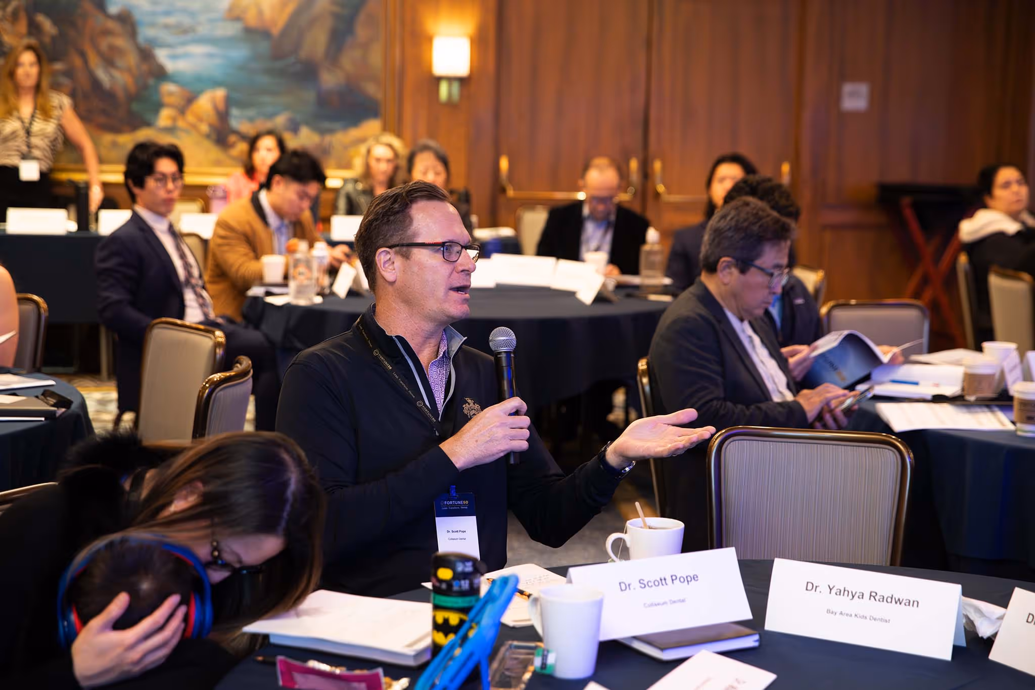 A Fortune executive coach presenting on stage to practice owners